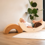 foam rainbow play set with child lying down